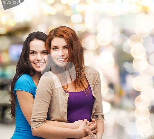Image of smiling teenage girls hugging