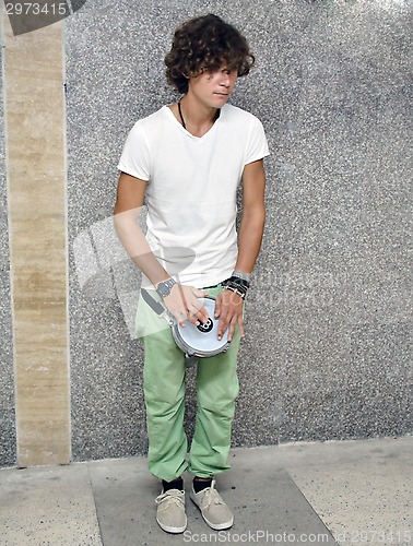 Image of Street musician with tambourine in the subway