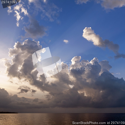 Image of Sunset and clouds over sea