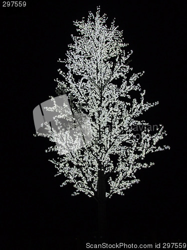 Image of Artificial tree with white bulbs on branches