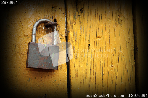 Image of metallic lock on wooden door