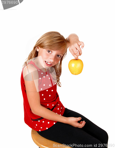 Image of Girl playing with an apple.