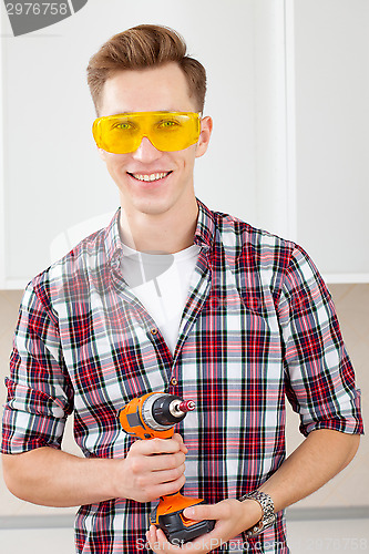 Image of repairman with a dril