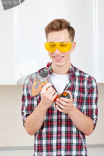 Image of repairman with a dril