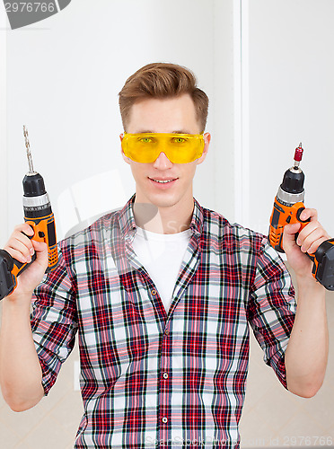 Image of  repairman with a drill and a screwdriver