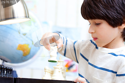 Image of boy playing a game of chess