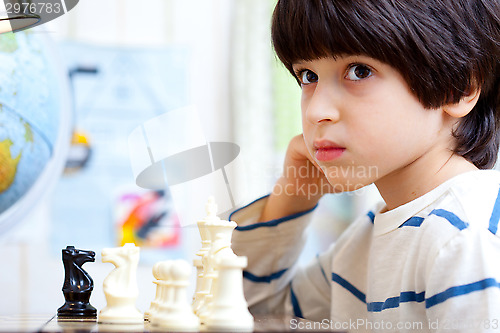 Image of boy playing a game of chess