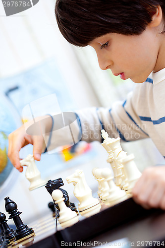 Image of boy playing a game of chess