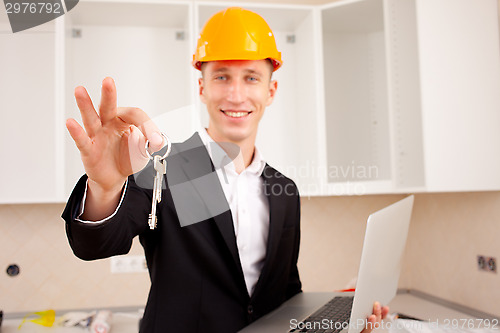 Image of smiling engineer gives keys