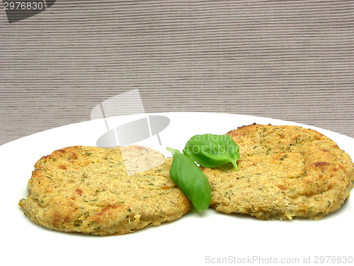 Image of Round flat potato dough cakes with basil 