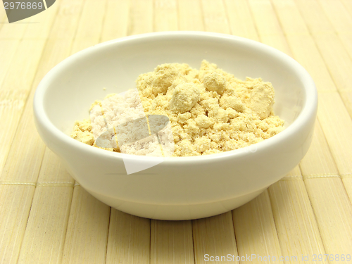 Image of Soy meal in a little white bowl of chinaware on a placemat