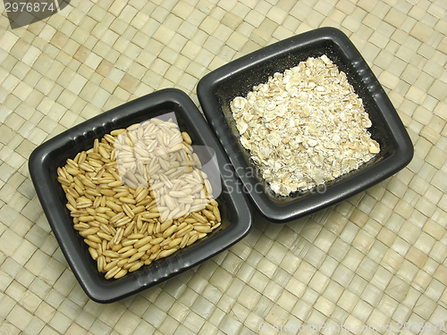 Image of Bowls of chinaware with cereal and wholemeal on rattan underlay