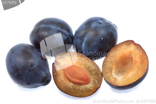 Image of Three plums and one halved