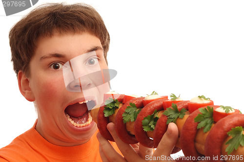 Image of Boy eating big crazy sandwich