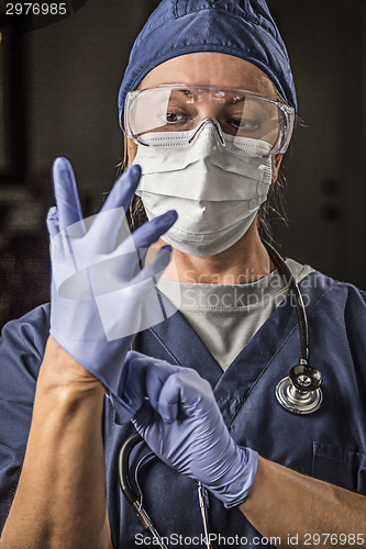 Image of Concerned Female Doctor or Nurse Putting on Protective Facial We