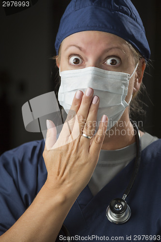 Image of Shocked Female Doctor with Hand in Front of Mouth