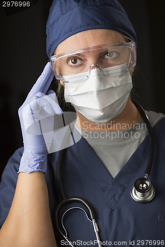 Image of Concerned Female Doctor or Nurse Wearing Protective Facial Wear