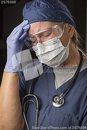 Image of Grimacing Female Doctor or Nurse Wearing Protective Wear