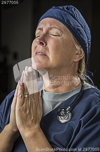 Image of Pleading in Prayer Female Doctor or Nurse