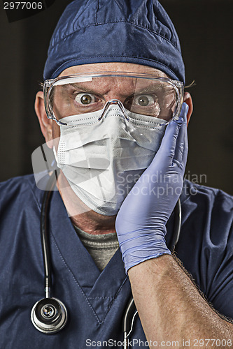 Image of Stunned Doctor or Nurse with Protective Wear and Stethoscope