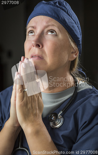 Image of Pleading in Prayer Female Doctor or Nurse