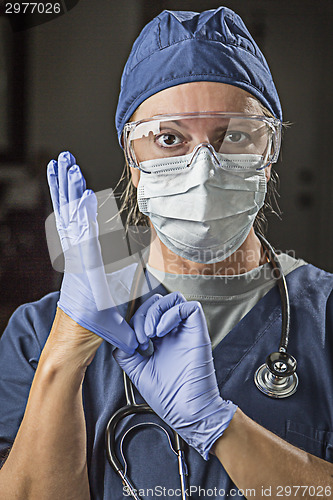 Image of Concerned Female Doctor or Nurse Putting on Protective Facial We