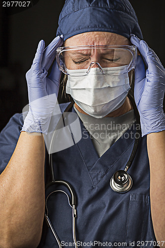 Image of Grimacing Female Doctor or Nurse Wearing Protective Wear