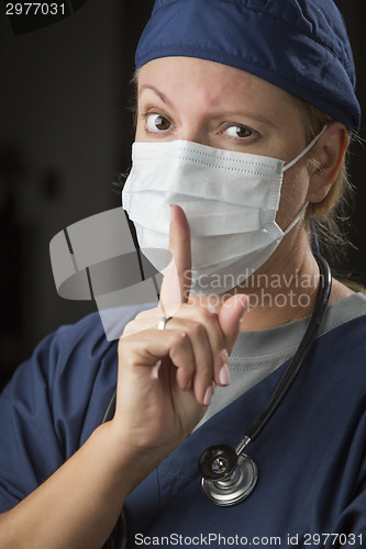 Image of Secretive Female Doctor with Finger in Front of Mouth