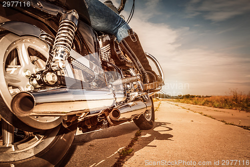 Image of Biker girl riding on a motorcycle