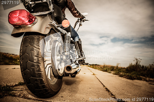 Image of Biker girl riding on a motorcycle