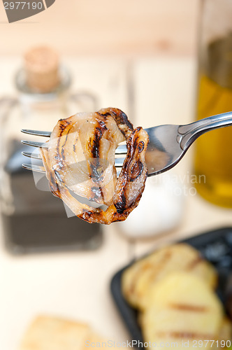 Image of grilled onion on a fork