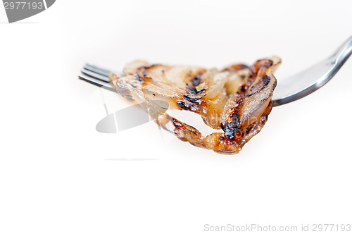 Image of grilled onion on a fork