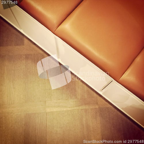 Image of Leather bench on wooden floor