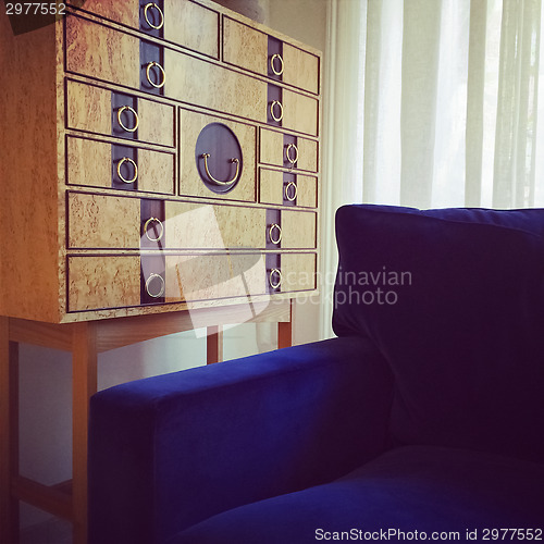 Image of Wooden dresser and blue velvet armchair