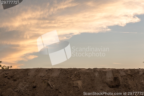 Image of Large pile of soil under blue sky