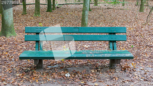 Image of Wooden park bench in a forrest