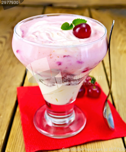 Image of Dessert milk with cherry on paper napkin