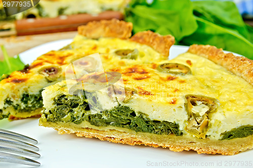 Image of Pie with spinach and olives on plate