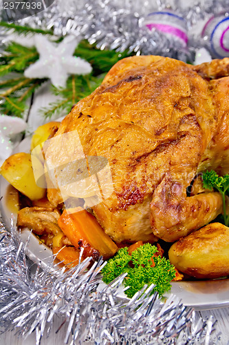 Image of Chicken Christmas with vegetables and silver tinsel