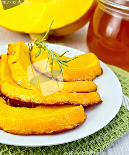 Image of Pumpkin baked with honey in bowl on board