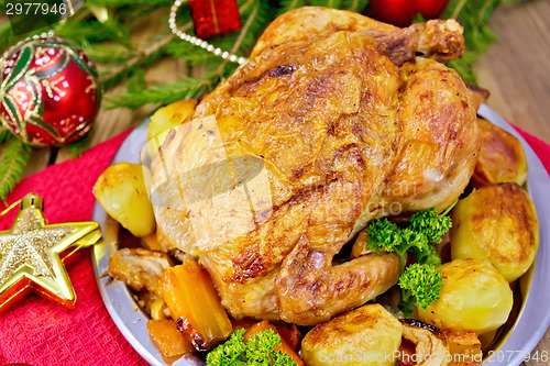 Image of Chicken with red Christmas toys on board