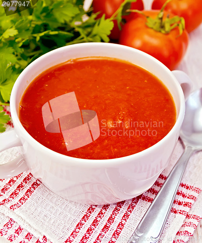 Image of Soup tomato on napkin with spoon