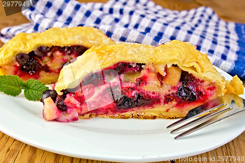 Image of Strudel with black currants and napkin on board