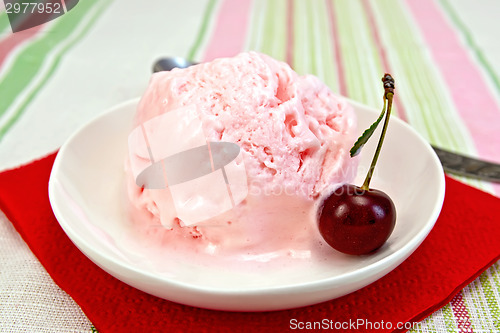 Image of Ice cream cherry on red paper napkin