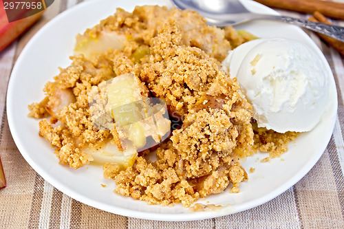 Image of Crumble with rhubarb in dish on linen tablecloth