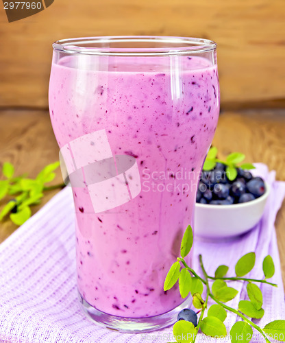 Image of Milkshake with blueberries and napkin on board