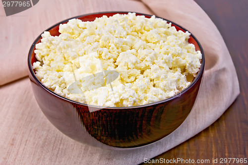 Image of Curd in wooden bowl on board with cloth