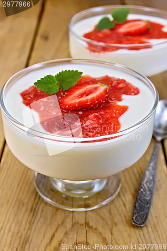 Image of Dessert milk with strawberry in goblet on board