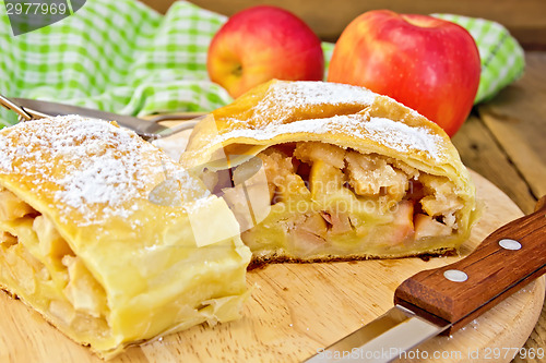 Image of Strudel with apples and napkin on board