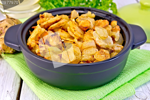 Image of Jerusalem artichokes roasted in pan on napkin and light board